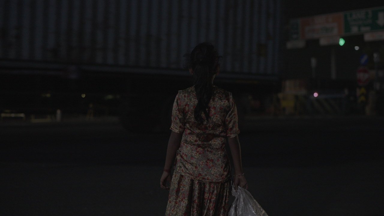 Yaakai child seated in night exterior